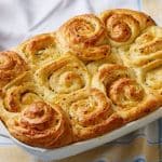 A top-down view of golden cheese rolls with swirls.