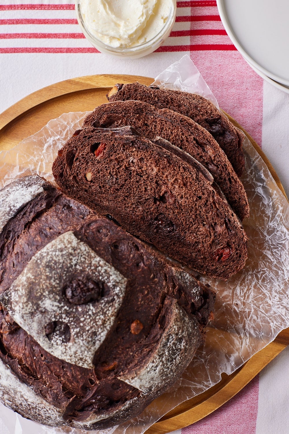 Chocolate Sourdough Bread14 Half loaf of Chocolate Sourdough Bread with three slices, served with butter on the side.