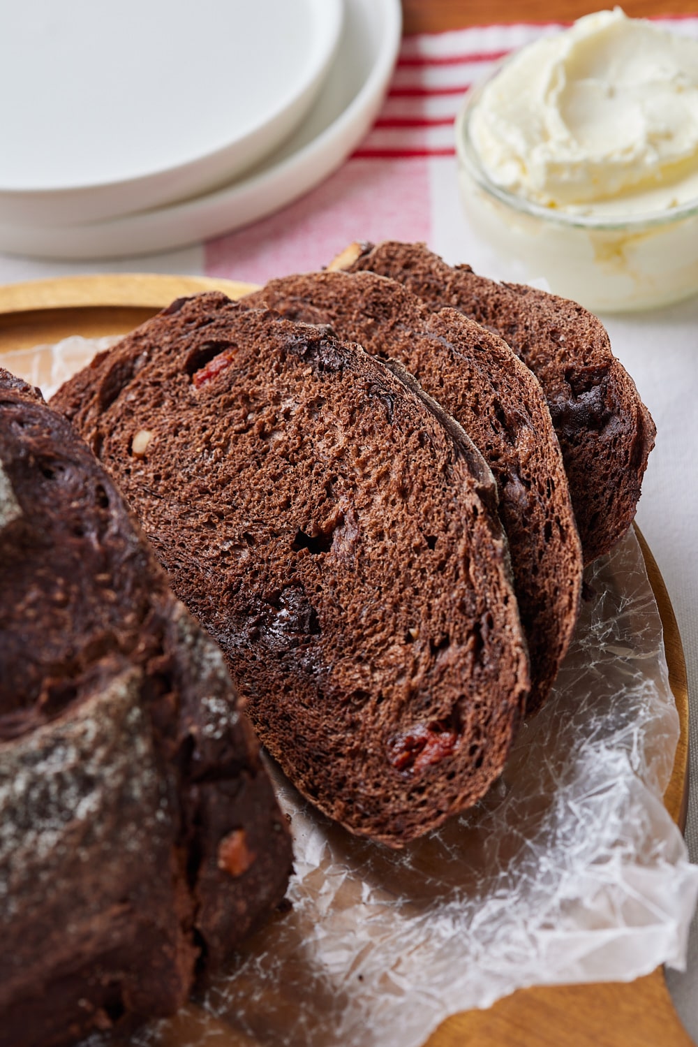 Chocolate Sourdough Bread15 A close-up shot at chocolate sourdough bread slices shows its soft bubbly crumb. served with butter on the side.