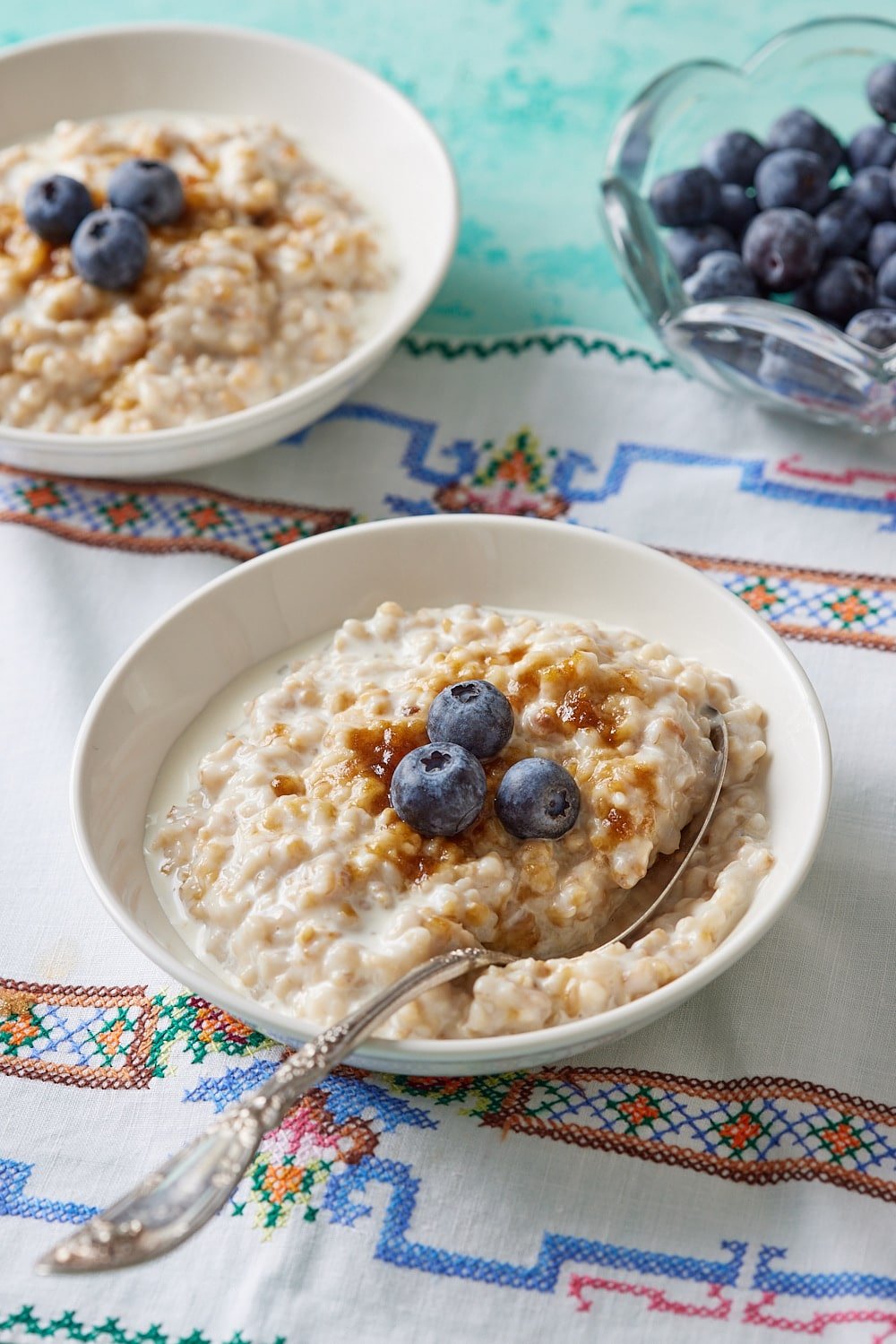 Irish Oats5 Irish Oats served in two bowls with brown sugar and blueberries.