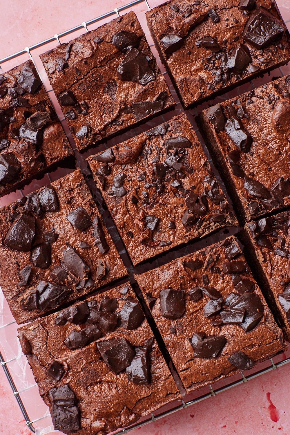 Sourdough Brownies8 Top down view of squares of sourdough brownies with shiny and crinkled top with chocolate chunks.