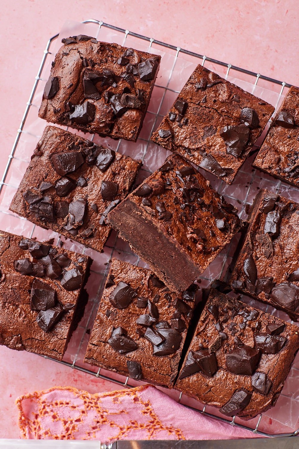 Sourdough Brownies9.2 Nine squares of sourdough brownies on the cooling rack with one piece showing the fudge center.
