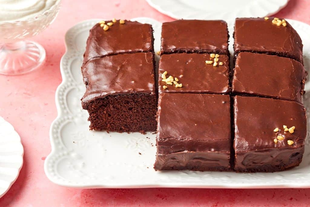 Easy Chocolate Frosting is used on the moist chocolate cake served on the platter.