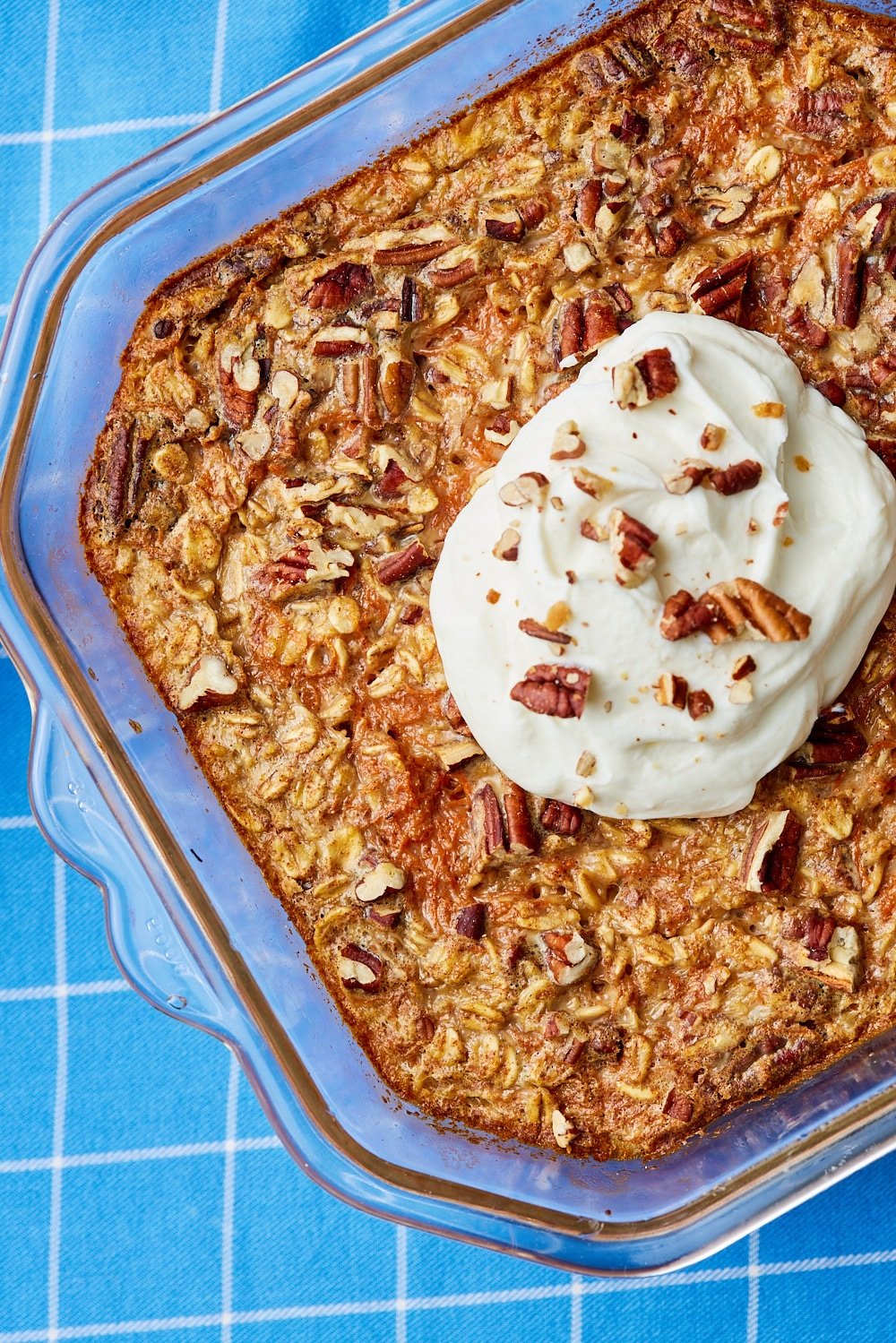 Carrot Cake Baked Oats7 Carrot Cake Baked Oatmeal served with a dollop of yogurt and pecans on top.