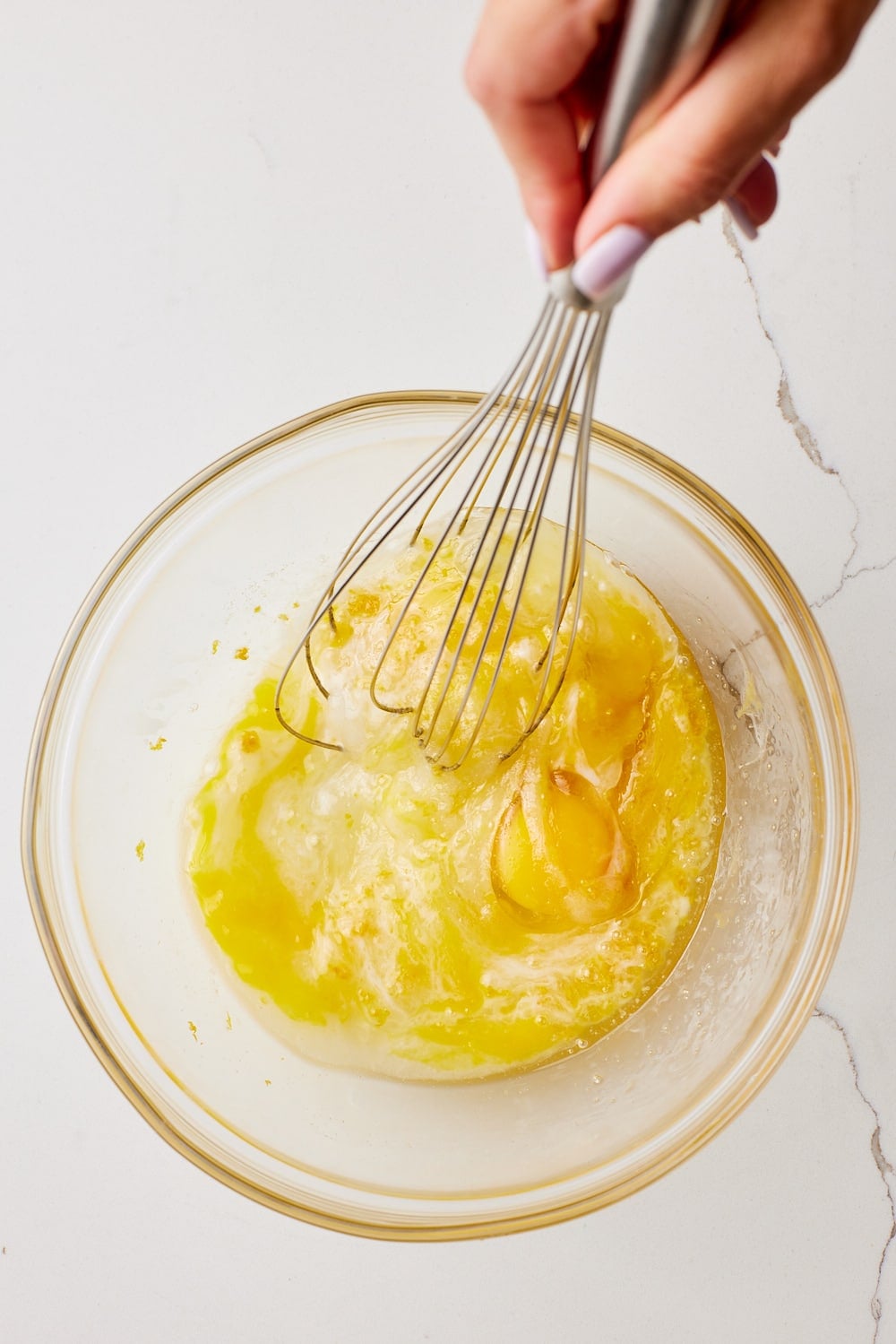 Whisk wet ingredients together for lemon biscotti. 