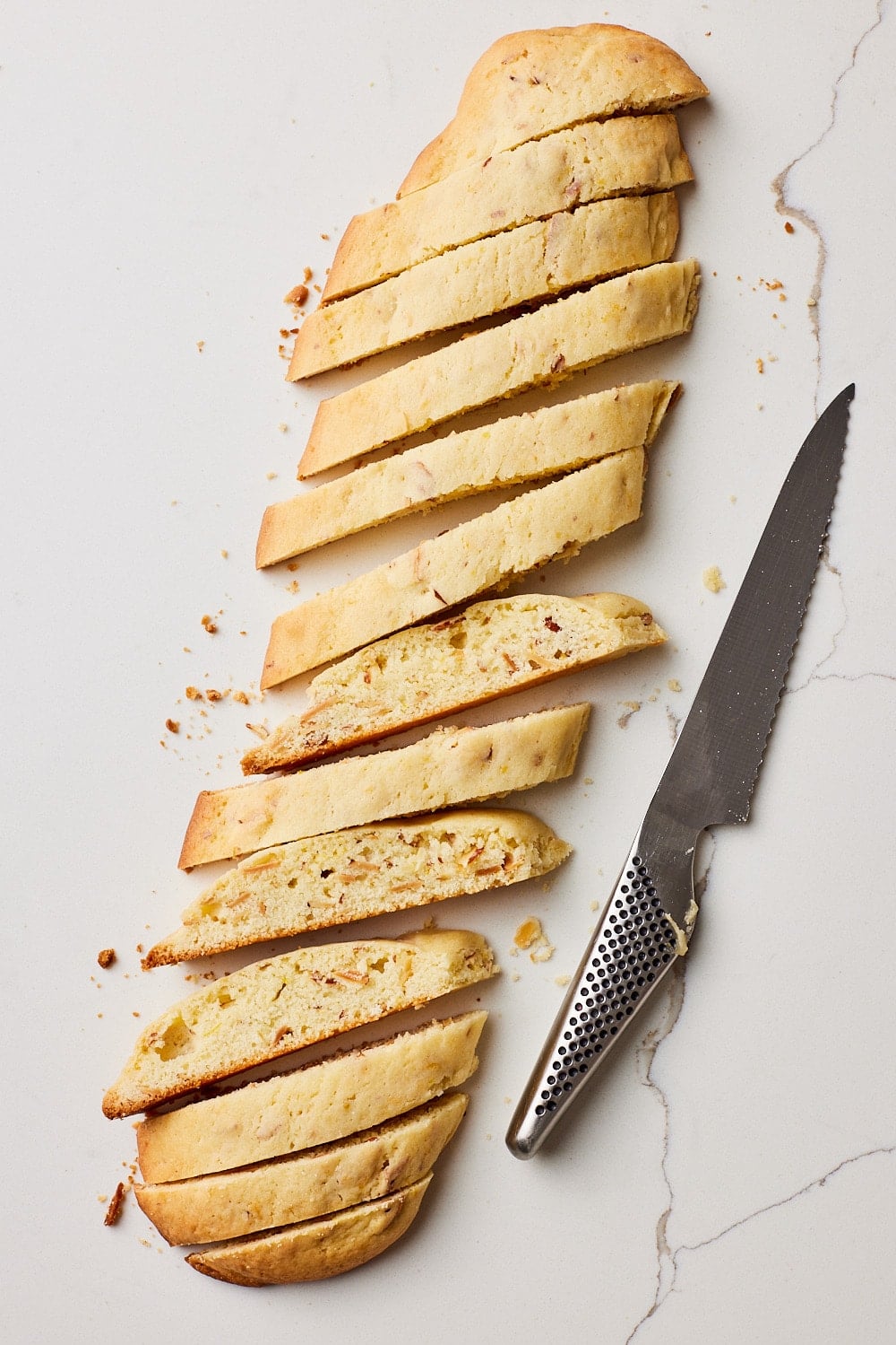 Using a serrated knife, slice each biscotti log at an angle into ¾ - inch (2 cm) thick slices. 