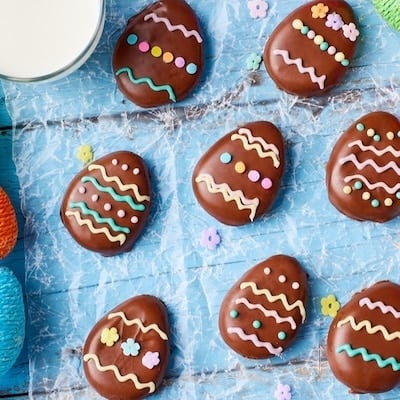 Top-down view of peanut butter eggs decorated with melted candy melts.