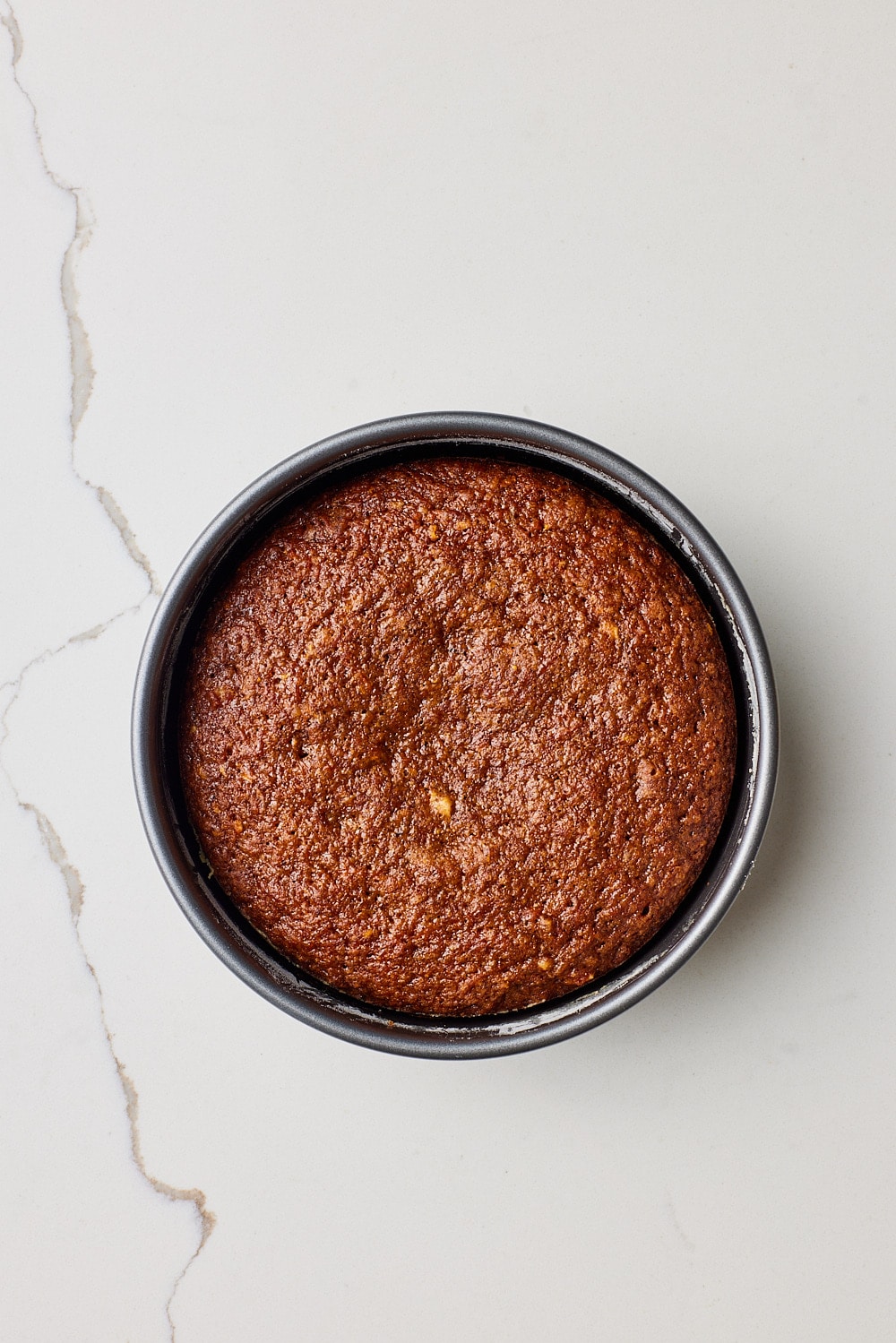 Small Carrot Cake Recipe6 Top down view of a baked small carrot cake.