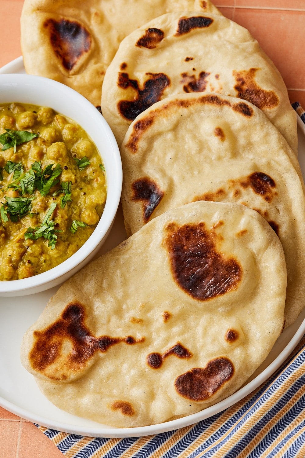 Sourdough Naan bread served with a bowl of chickpeas. 