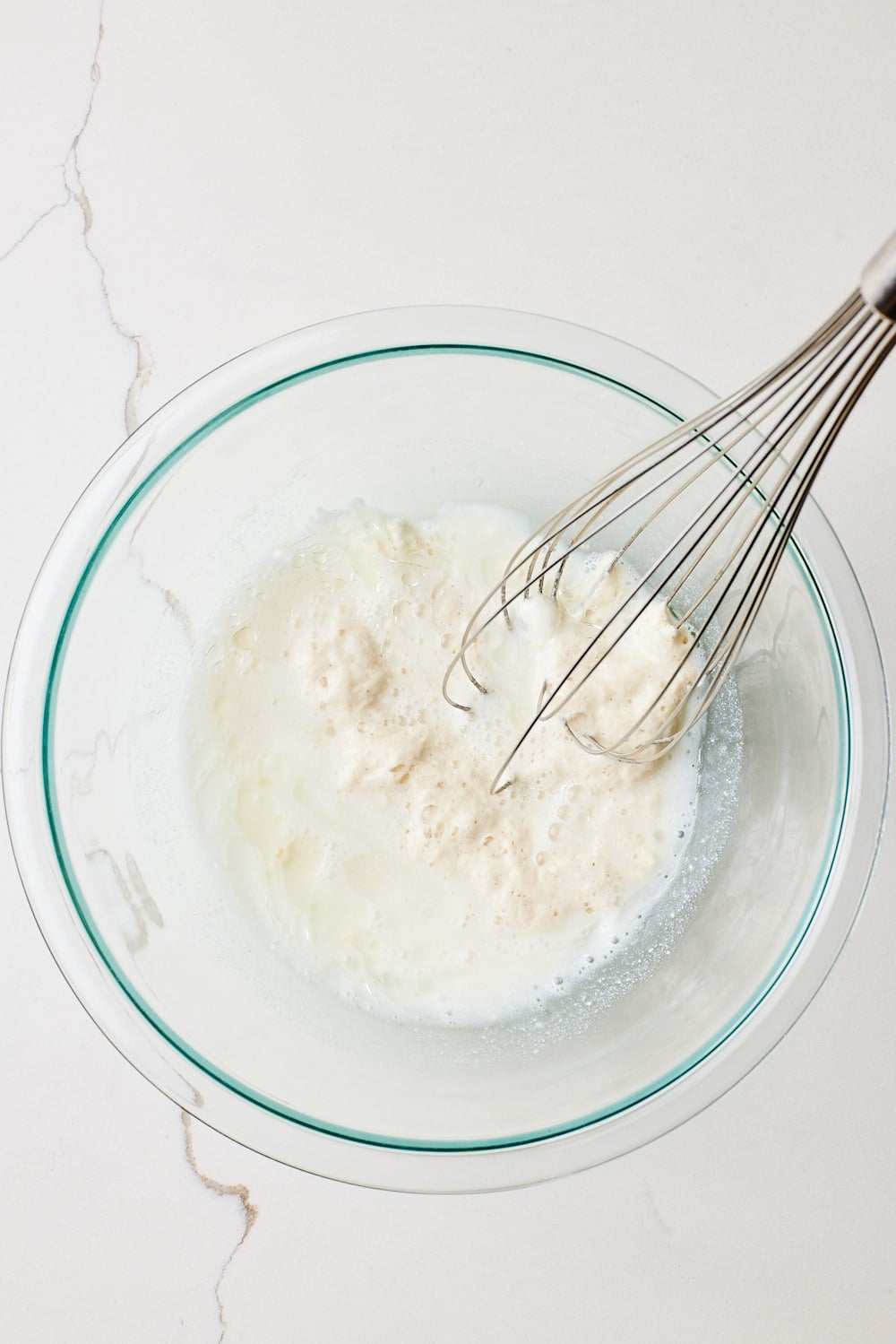 Mix sourdough starter with water in a bowl. 