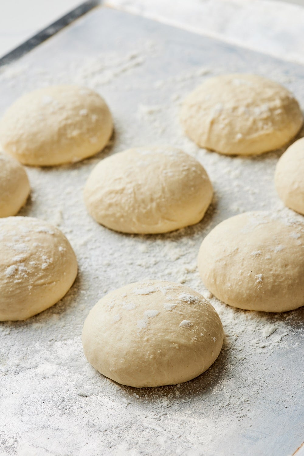 Sourdough naan dough ball resting & proofing on the baking tray. 