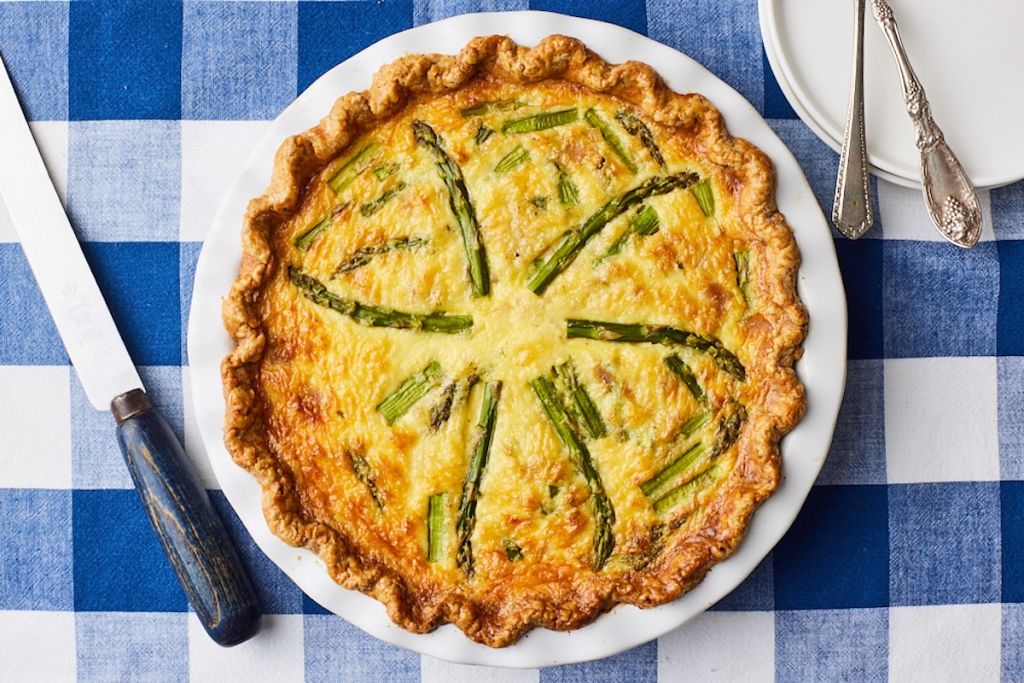 A top-down view of a golden Asparagus and Ham quiche.
