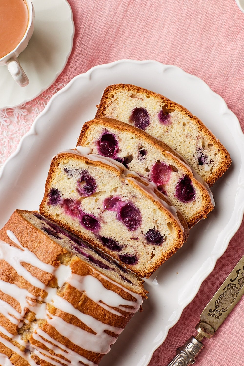 Lemon blueberry bread8 Lemon Blueberry Bread is glazed and sliced on the platter. Served with tea on the side.