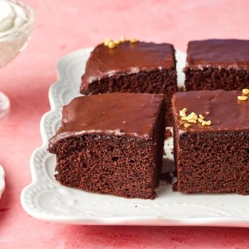 Close-up shot at one bowl chocolate cake showing the moist crumb and silky frosting.