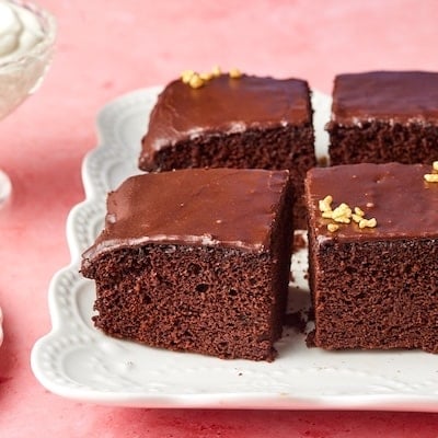 Close-up shot at one bowl chocolate cake showing the moist crumb and silky frosting.