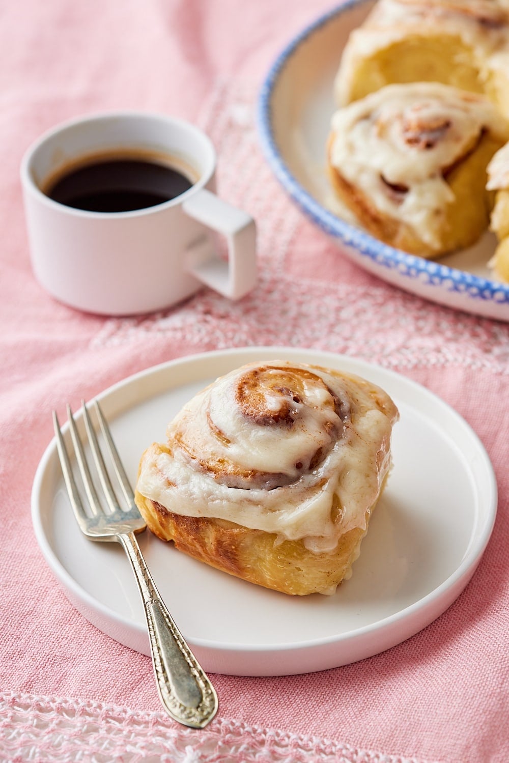 Sourdough Cinnamon Rolls19 A sourdough cinnamon roll is served on a dessert plate with coffee on the side.