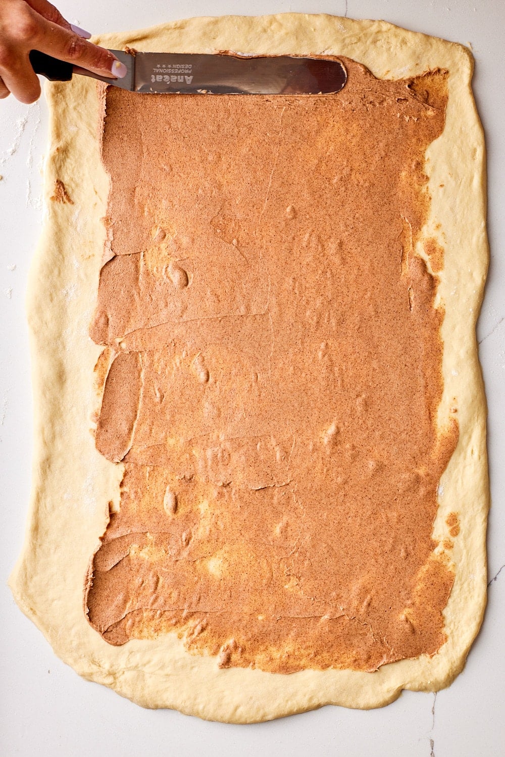Sourdough Cinnamon Rolls9 Spread cinnamon sugar filling evenly over the dough.