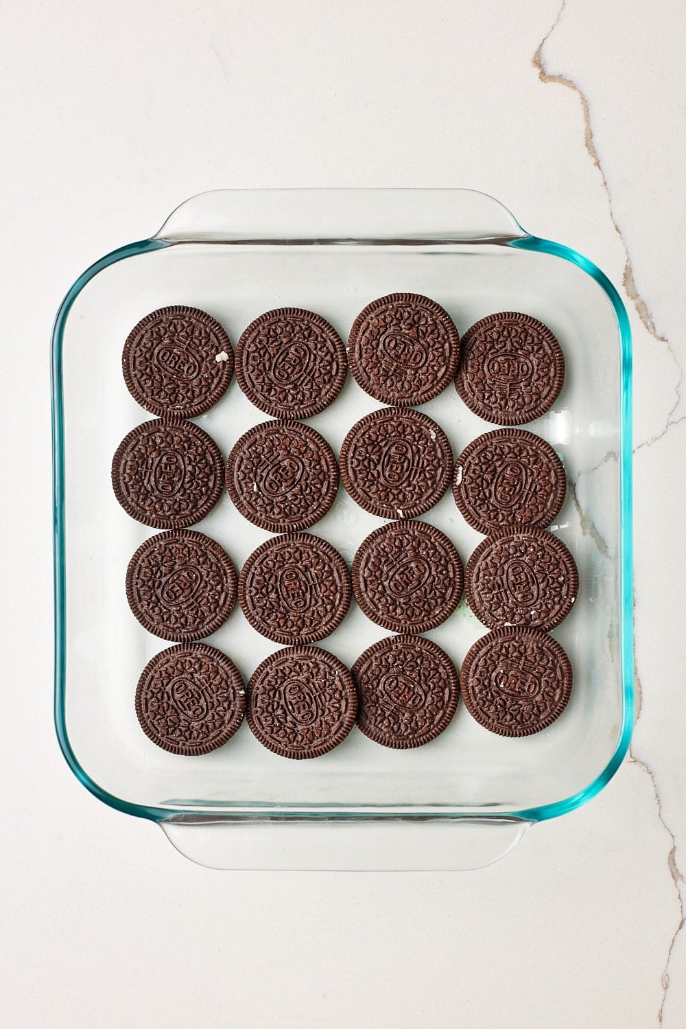 Arrange bottom layer: Arrange 16 Oreo halves in an even layer in an 8-inch (20 cm) square pan.