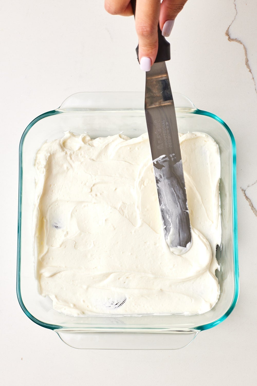 Spread one-third of the cream cheese filling evenly over the cookies.