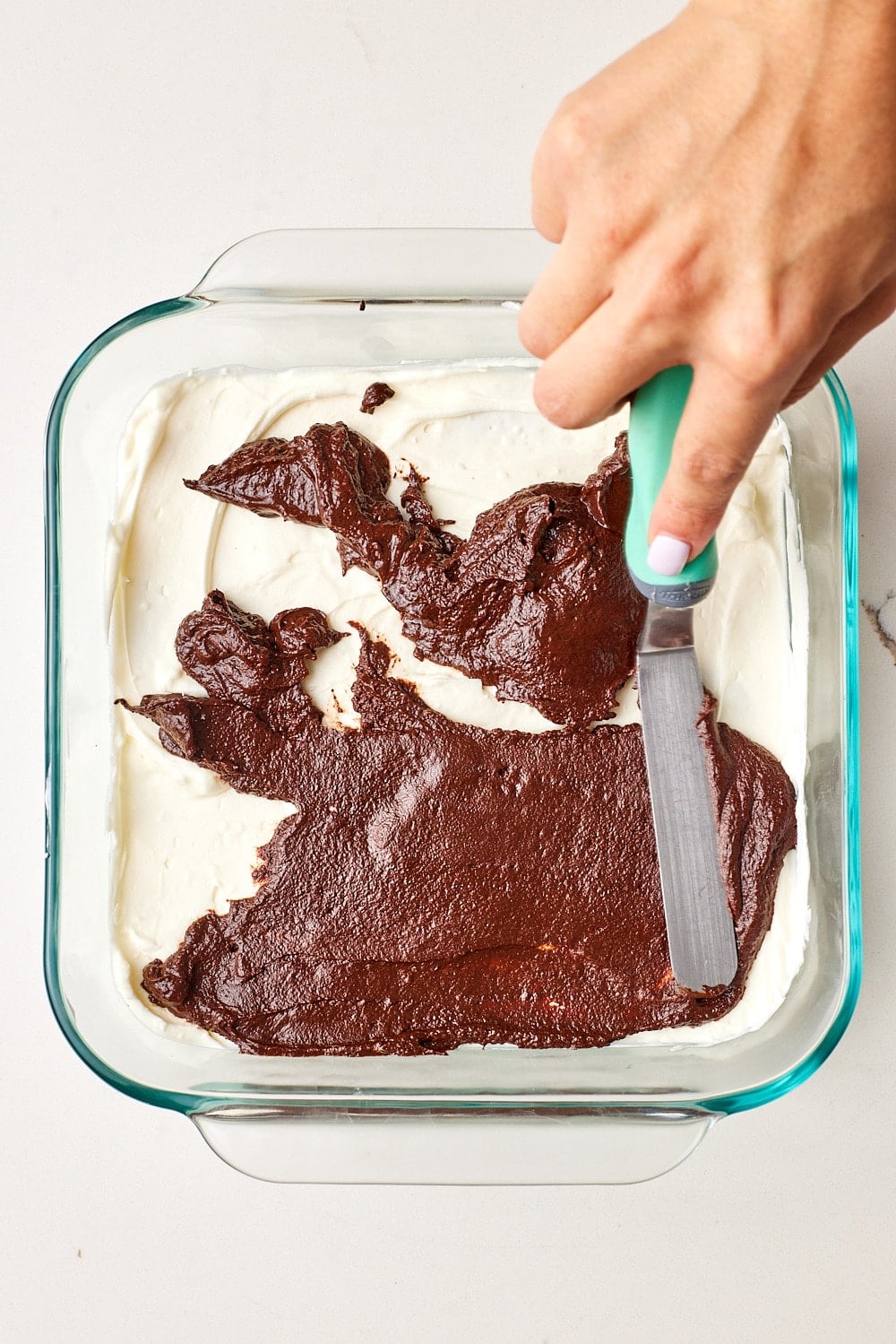 Top with ganache: Drizzle one-third of the bittersweet chocolate ganache over the filling.