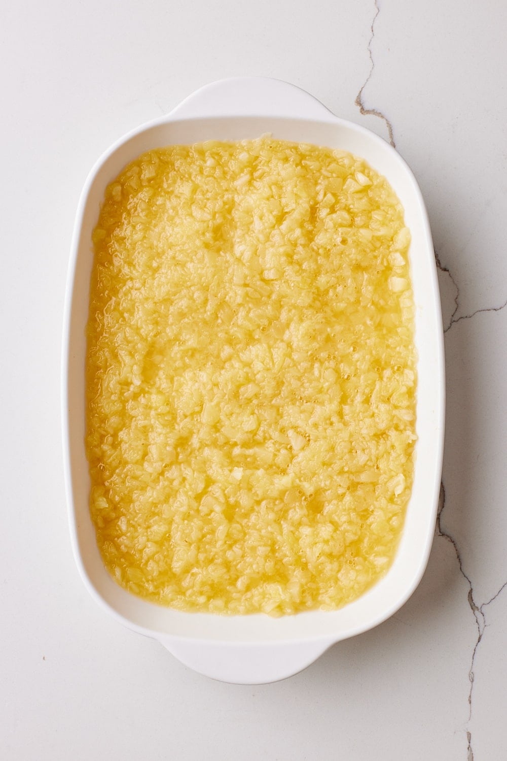 Pineapple Dump Cake2 Spread crushed pineapple into the baking dish.