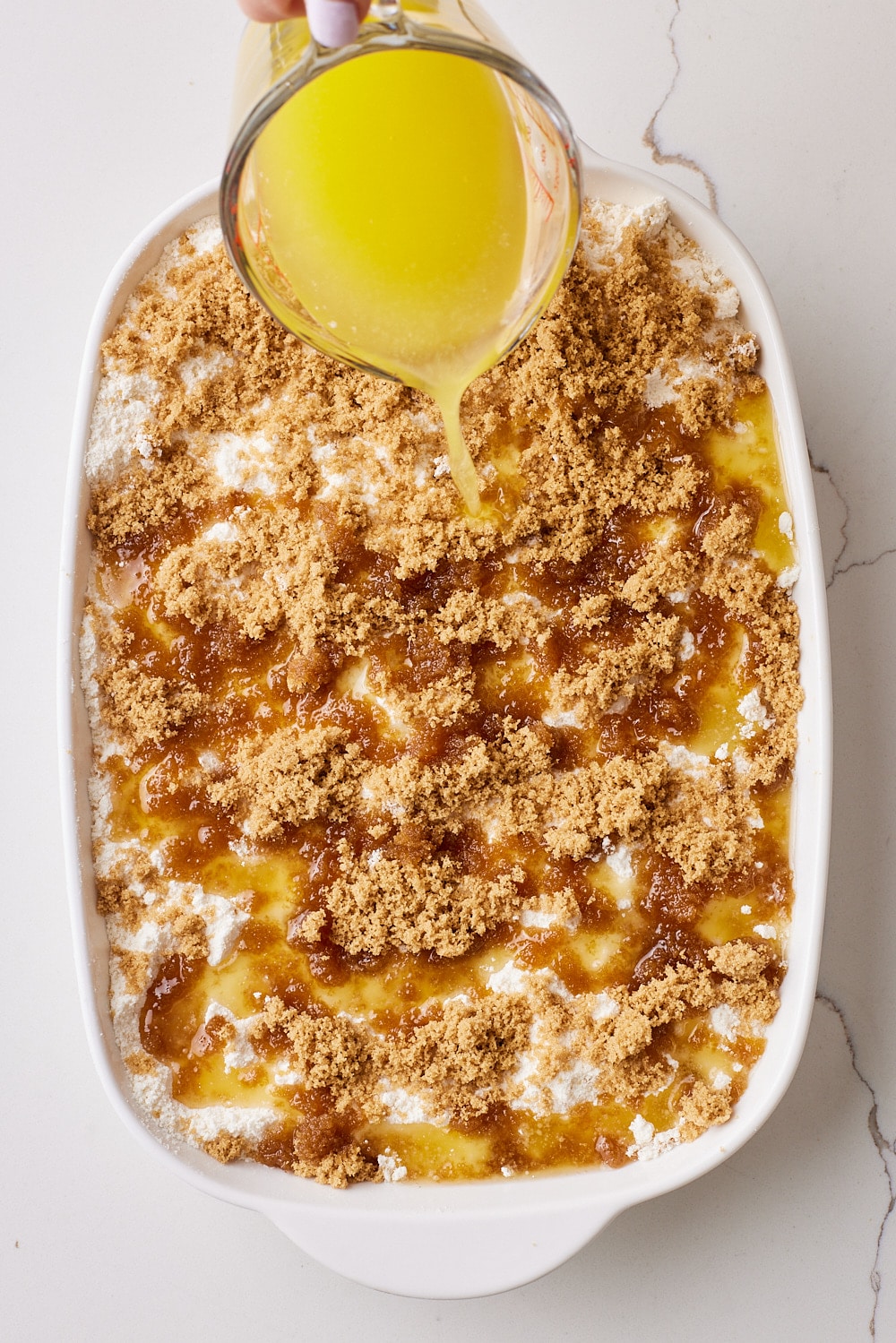 Pineapple Dump Cake5 Slowly drizzle the butter over the surface, ensuring all of the dry cake mix is moistened.