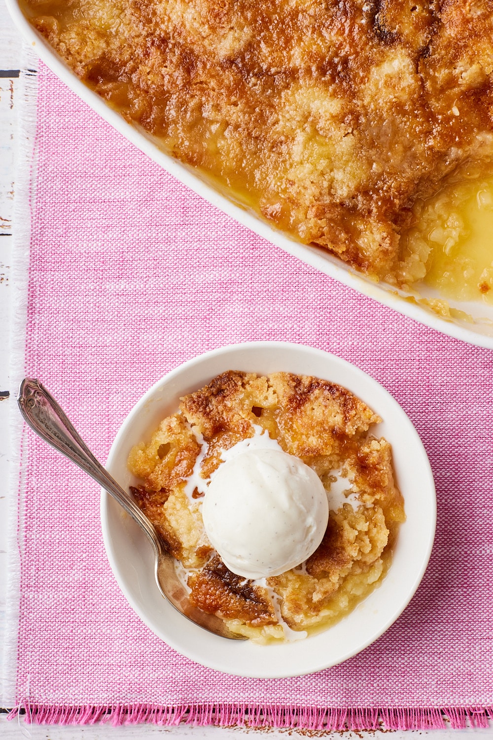 Pineapple Dump Cake8 Pineapple Dump Cake is served in a bowl with a scoop of ice cream.