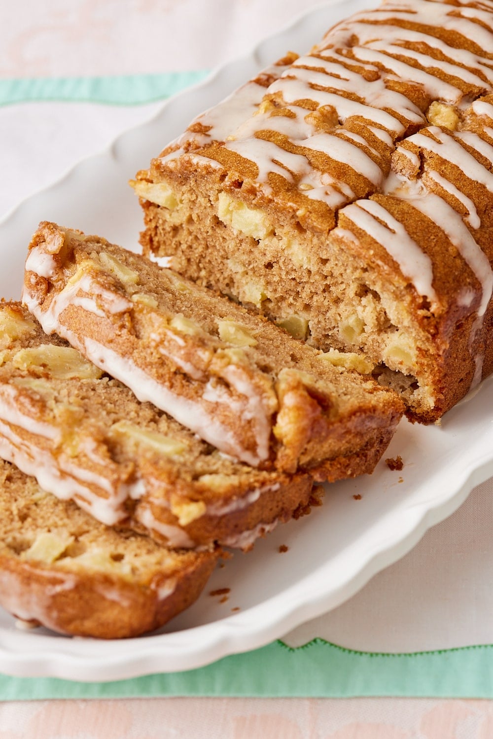 Apple Loaf Cake8 A close-up shot at sliced Apple Loaf Cake showing its most crumb loaded with apples and drizzled with glaze.