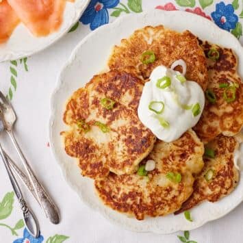 Top-down view of Boxty- Irish Potato Pancakes topped with sour cream and green onions.
