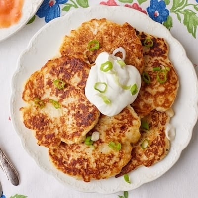 Top-down view of Boxty- Irish Potato Pancakes topped with sour cream and green onions.
