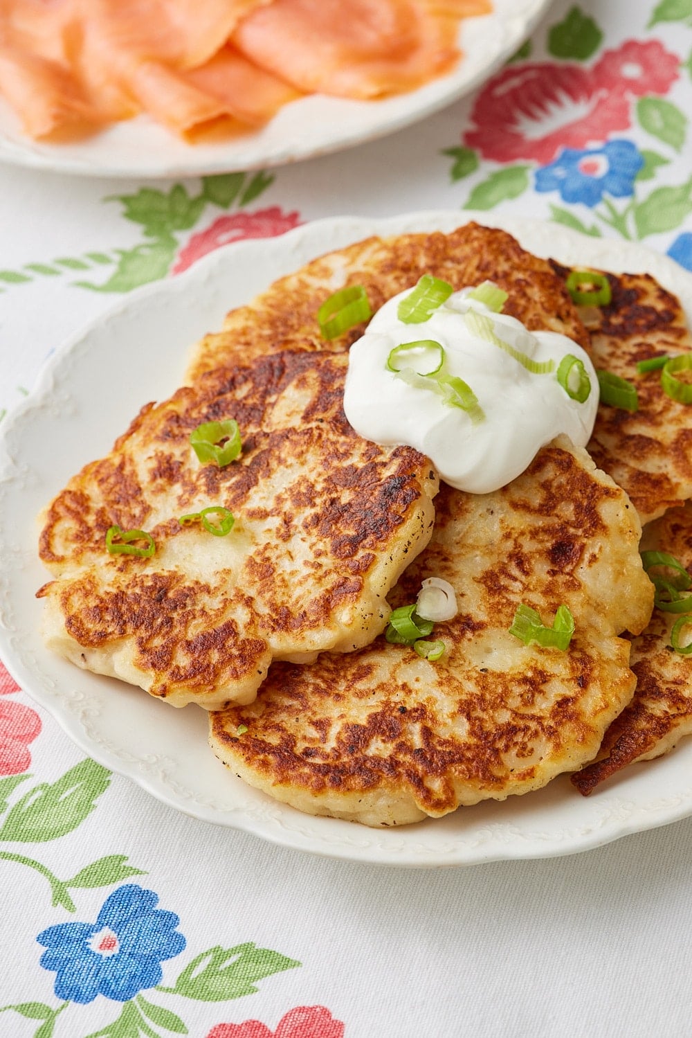 Boxty12 A plate of Irish Potato Pancakes served with sour cream on top and smoked salmon on the side.