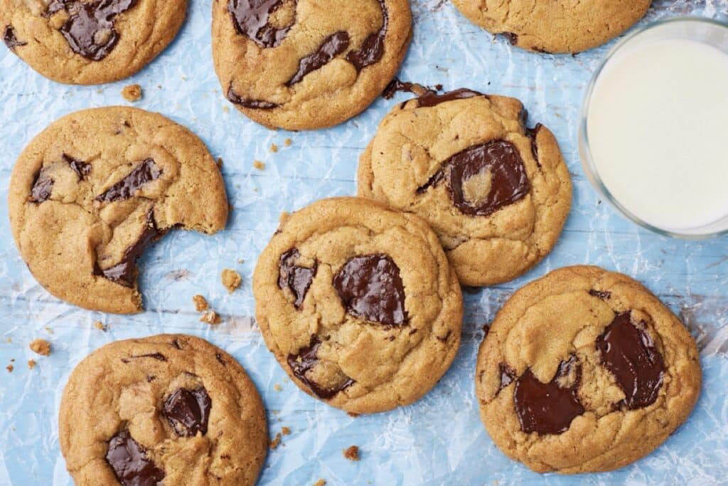Top down view of Brown Butter Chocolate Chip Cookies served with milk on the side.