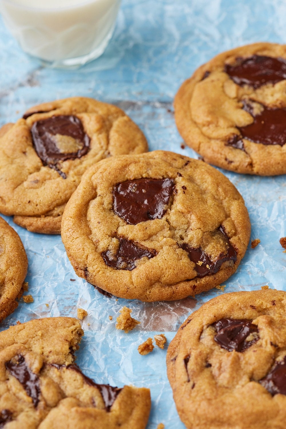 Brown Butter Chocolate Chip Cookies7 top down view of a few brown butter chocolate chip cookies with crinkled top and melted chocolate .