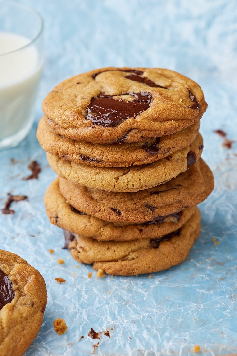 Brown Butter Chocolate Chip Cookies9 A close-up shot at a stack of brown butter chocolate chip cookies swerved with milk on the side.
