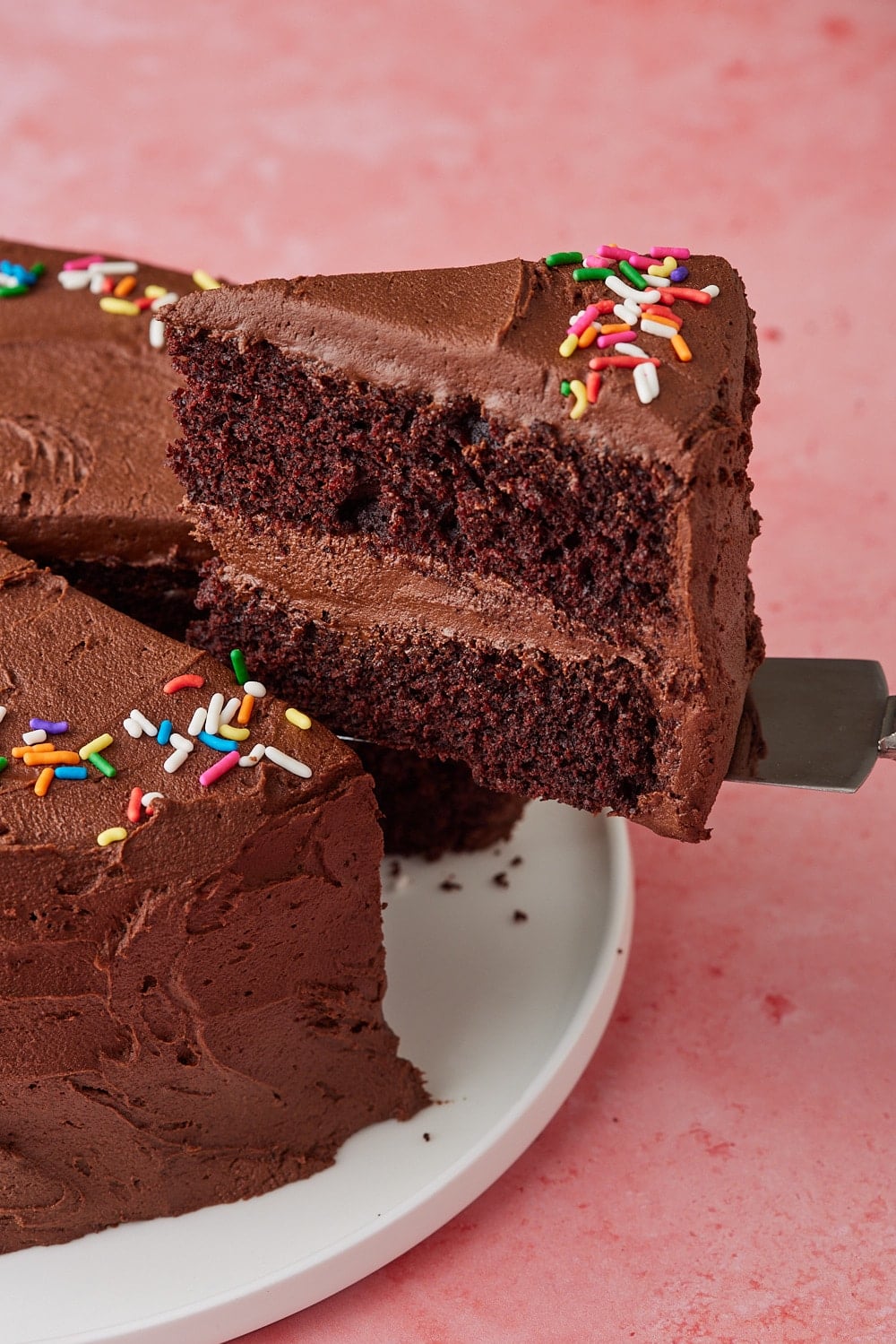 Chocolate Mayo Cake13 A close-up shot at a slice of chocolate cake shows its moist crumb and rich chocolate buttercream frosting.