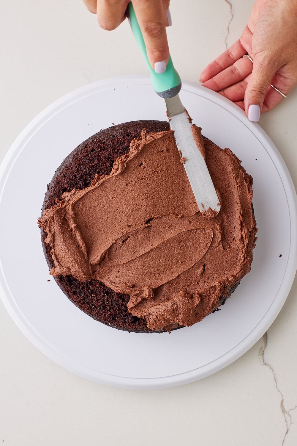 Chocolate Mayo Cake9 Frost the first cake layer on a plate.