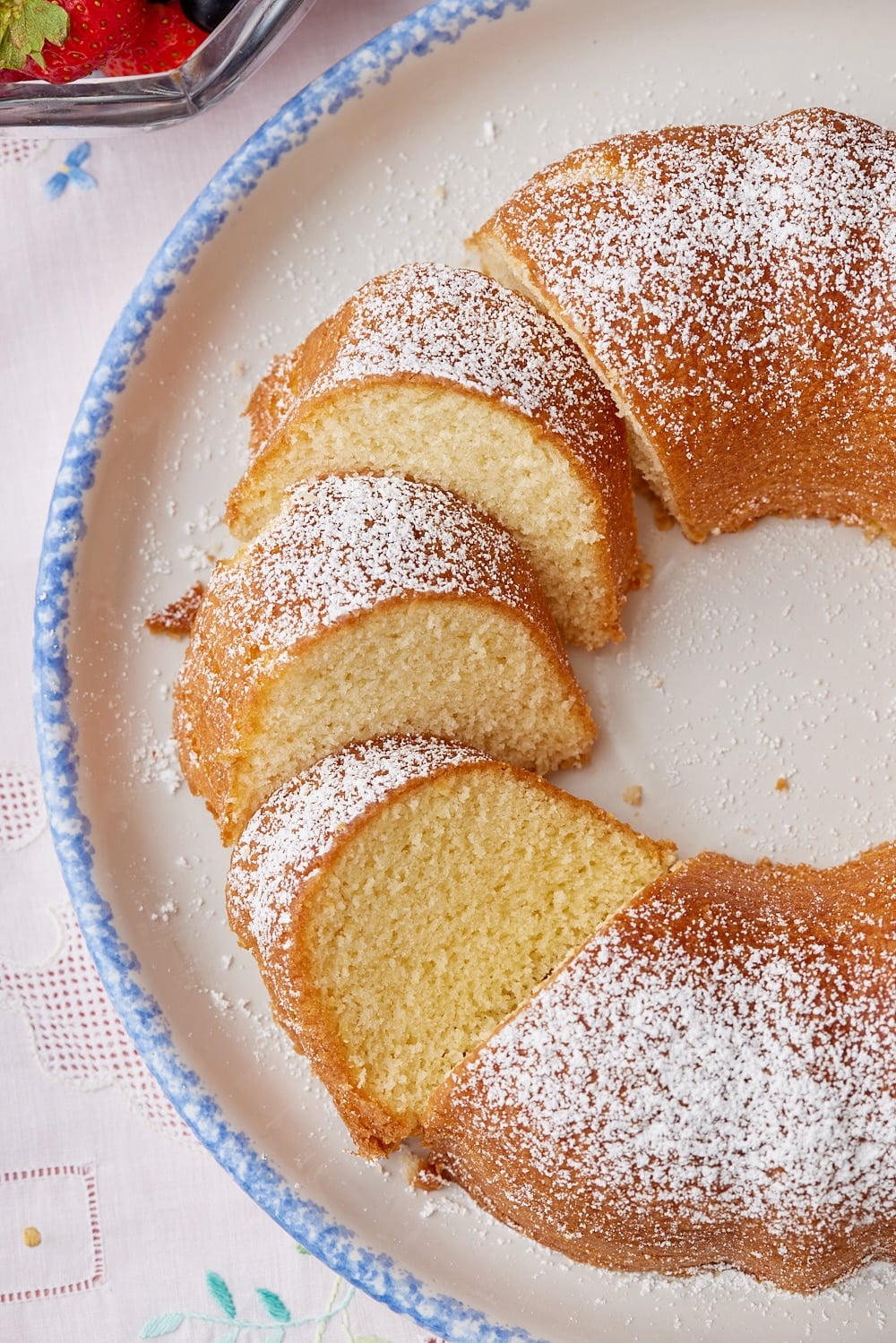 Hot Milk Cake11 Hot Milk Cake is dusted with powdered sugar and partially sliced.