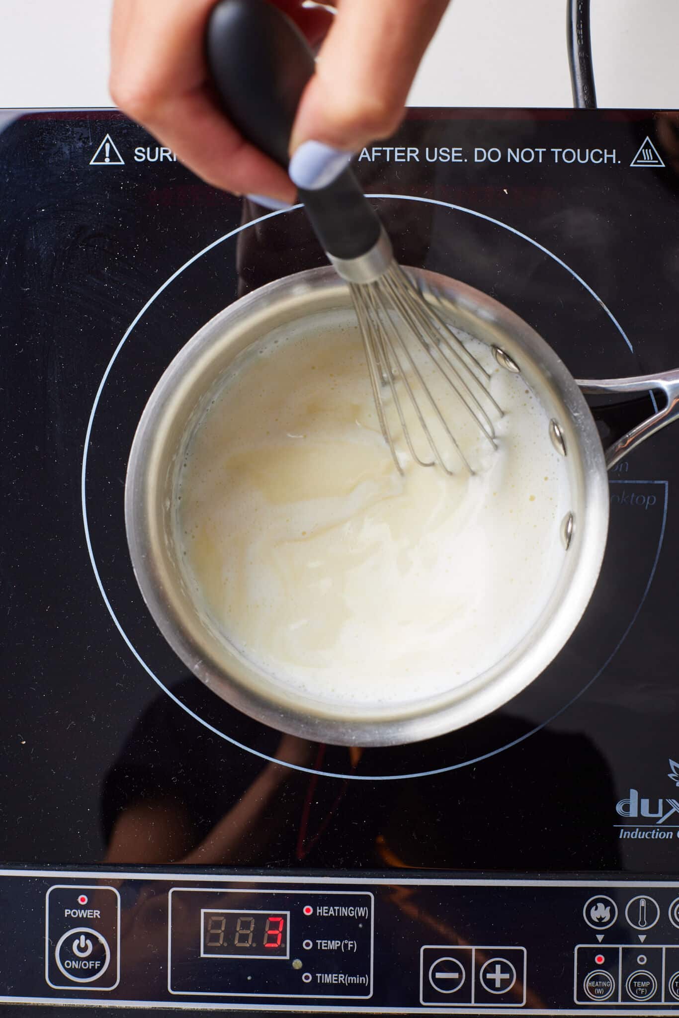 Hot Milk Cake4 Milk is heated in the saucepan with a whisk in. Bubbles started forming around the edges.