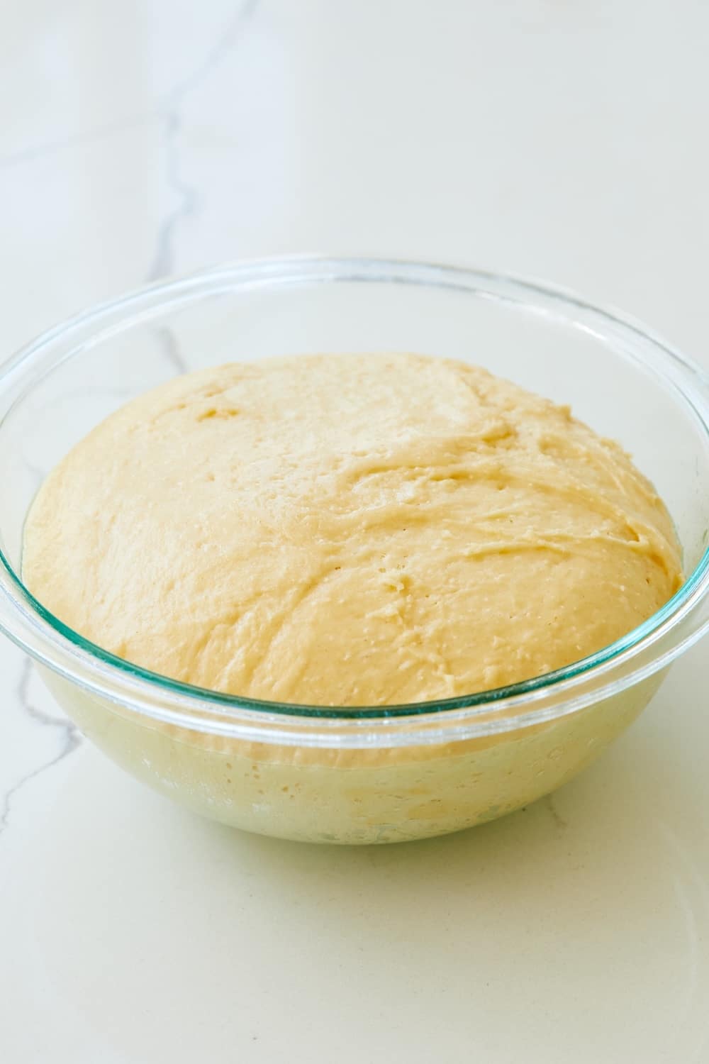 Japanese Milk Bread (Hokkaido) is proofed in a glass bowl until doubled in size. 