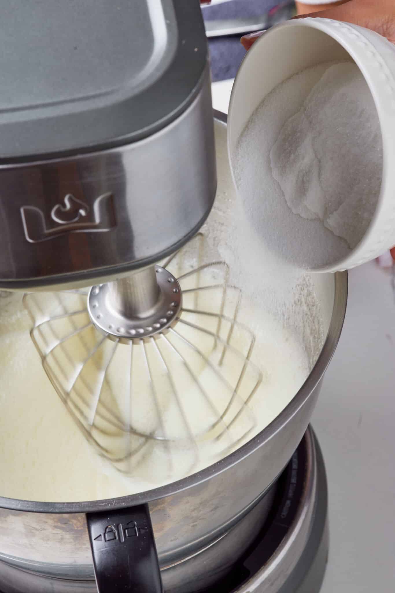 Add sugar, whipping to soft, glossy peaks,