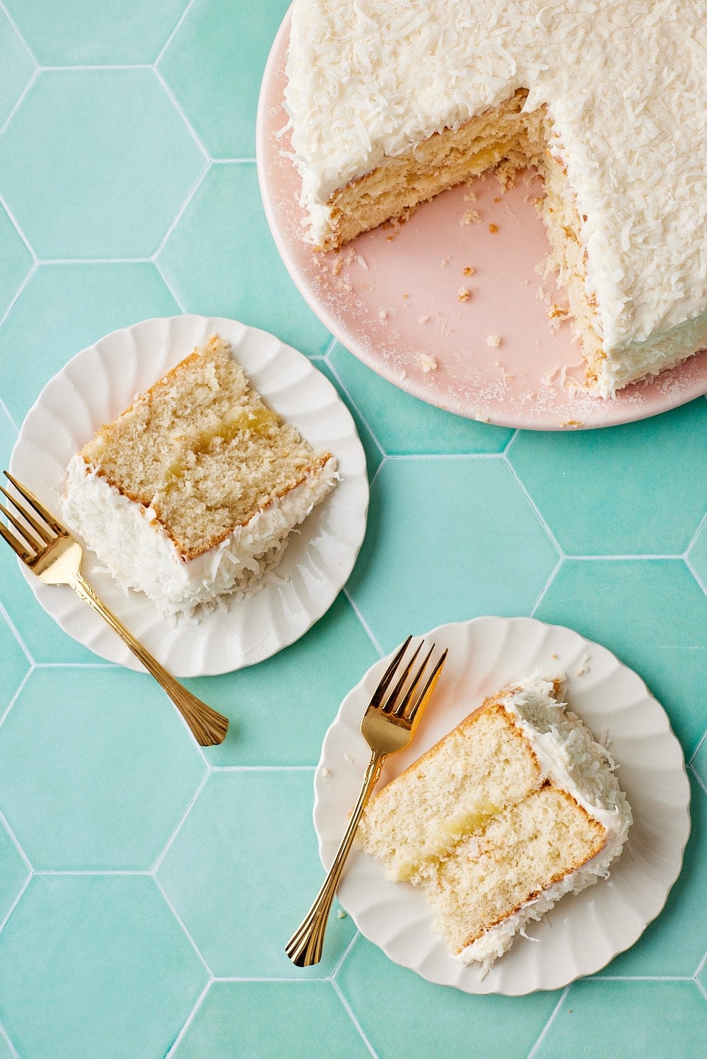 Pineapple Coconut Cake18 Two slices of pineapple coconut cake served next to the remaining cake.