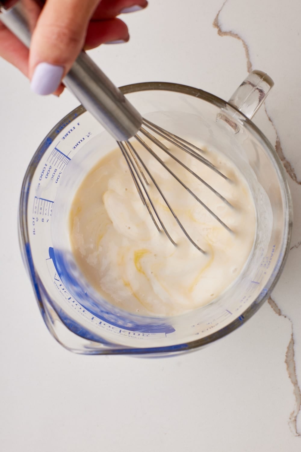 Pineapple Coconut Cake4 In a large jug, whisk together the egg whites, whole egg, coconut milk, vanilla extract, and coconut extract.