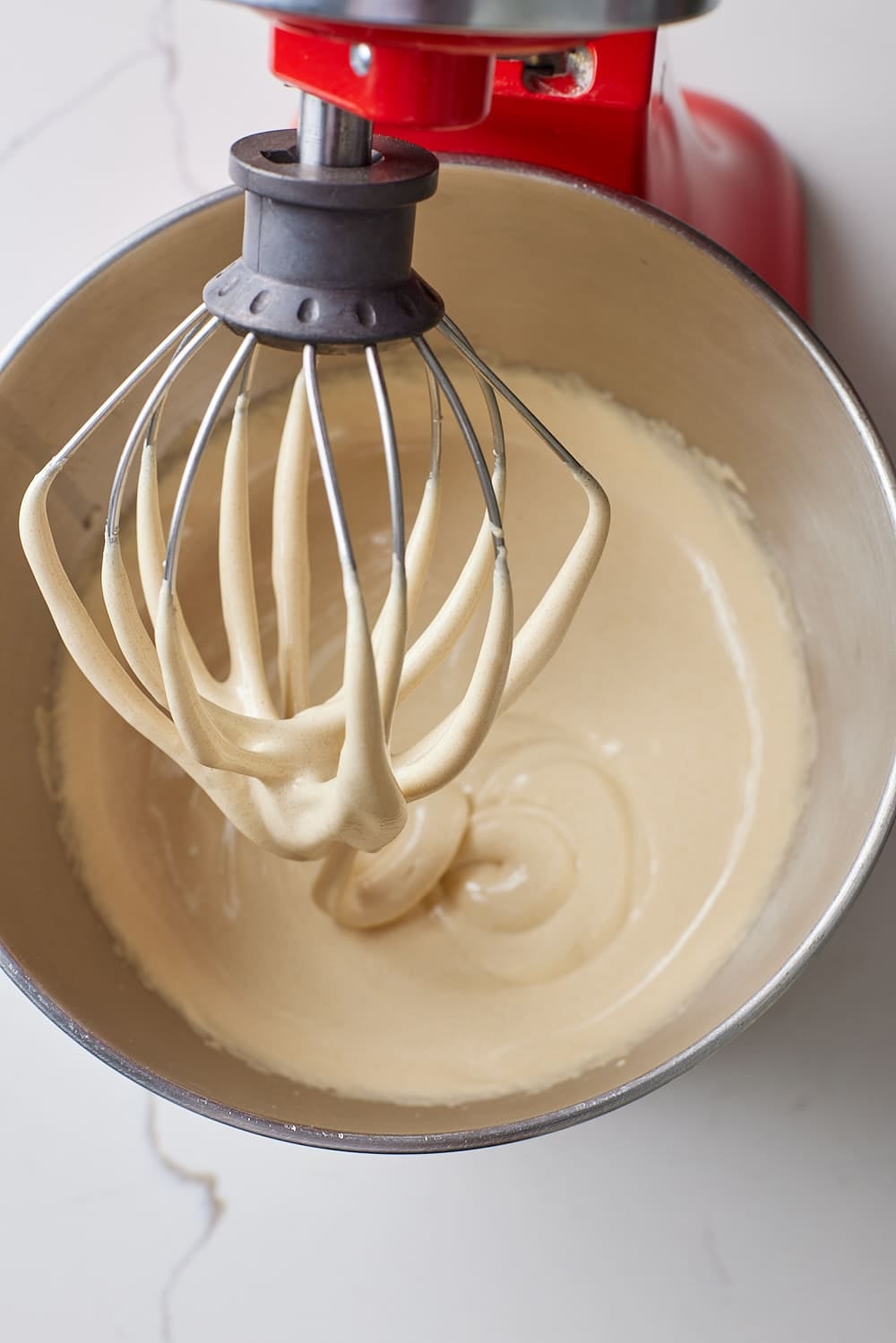Wet ingredients of sheet pan brownies whipped thick and glossy in the stand mixer bowl. 