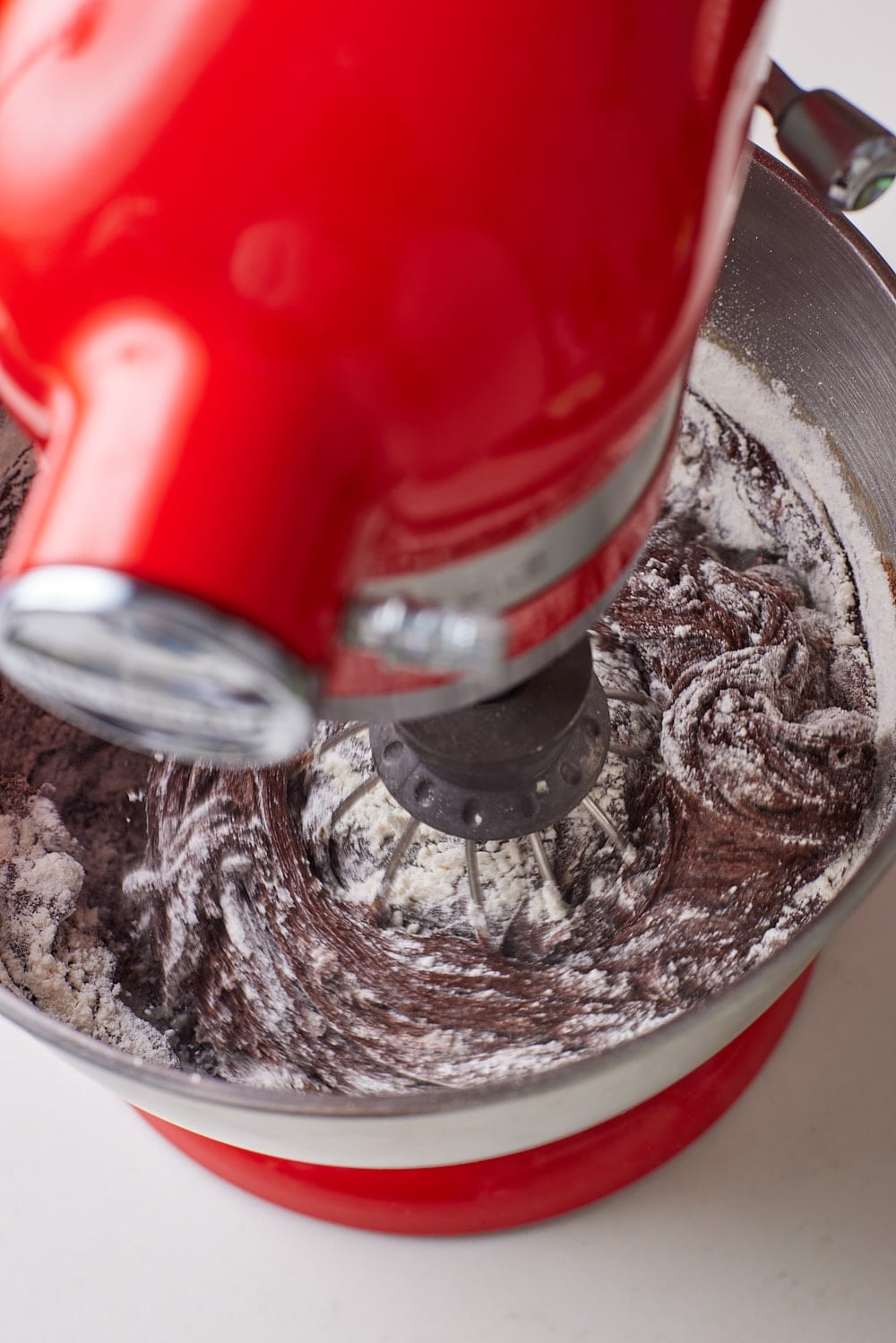 Fold in the flour mixture just until combined, then spread the batter evenly into the prepared sheet pan.