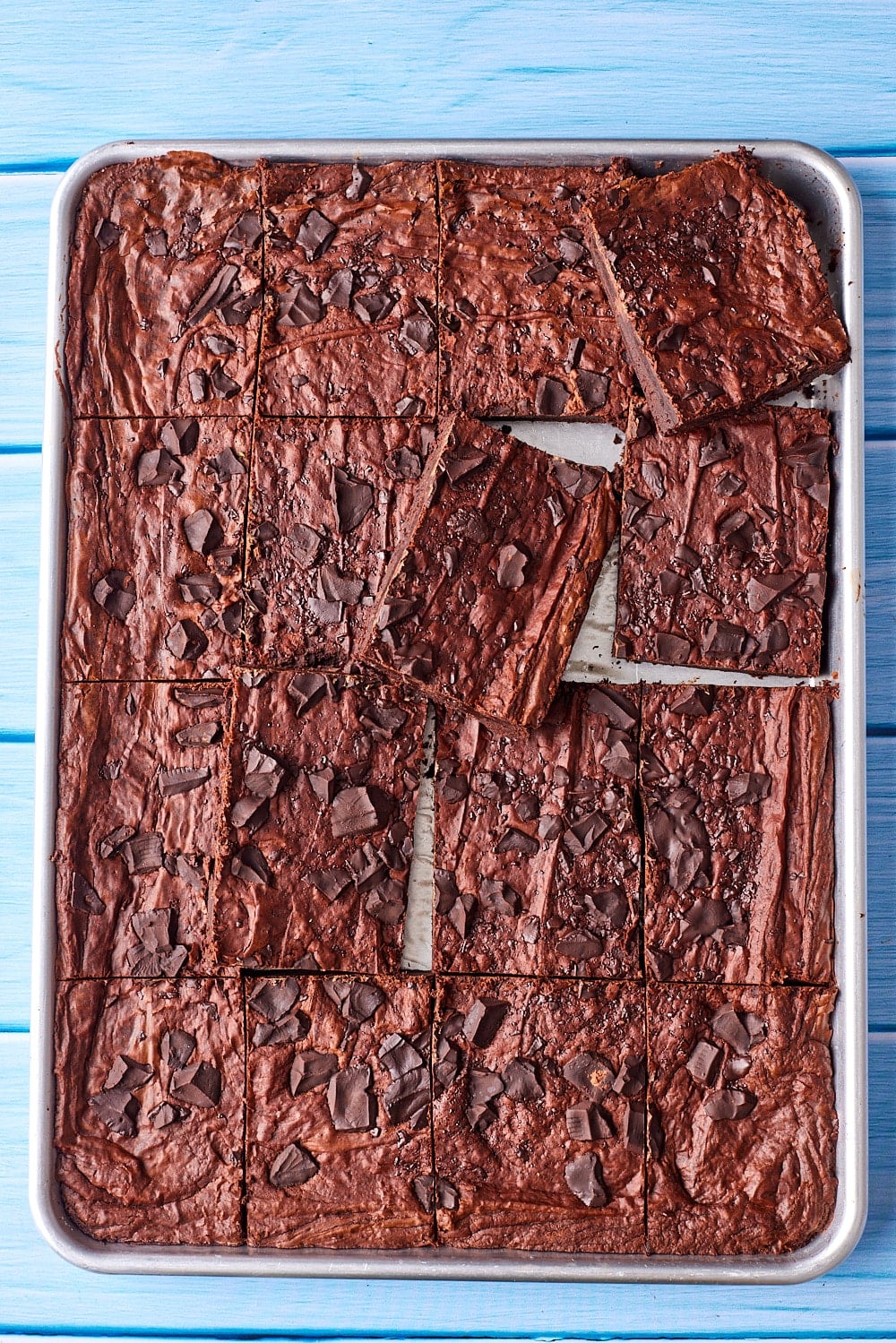 Sheet pan brownies are cut into big squares. 