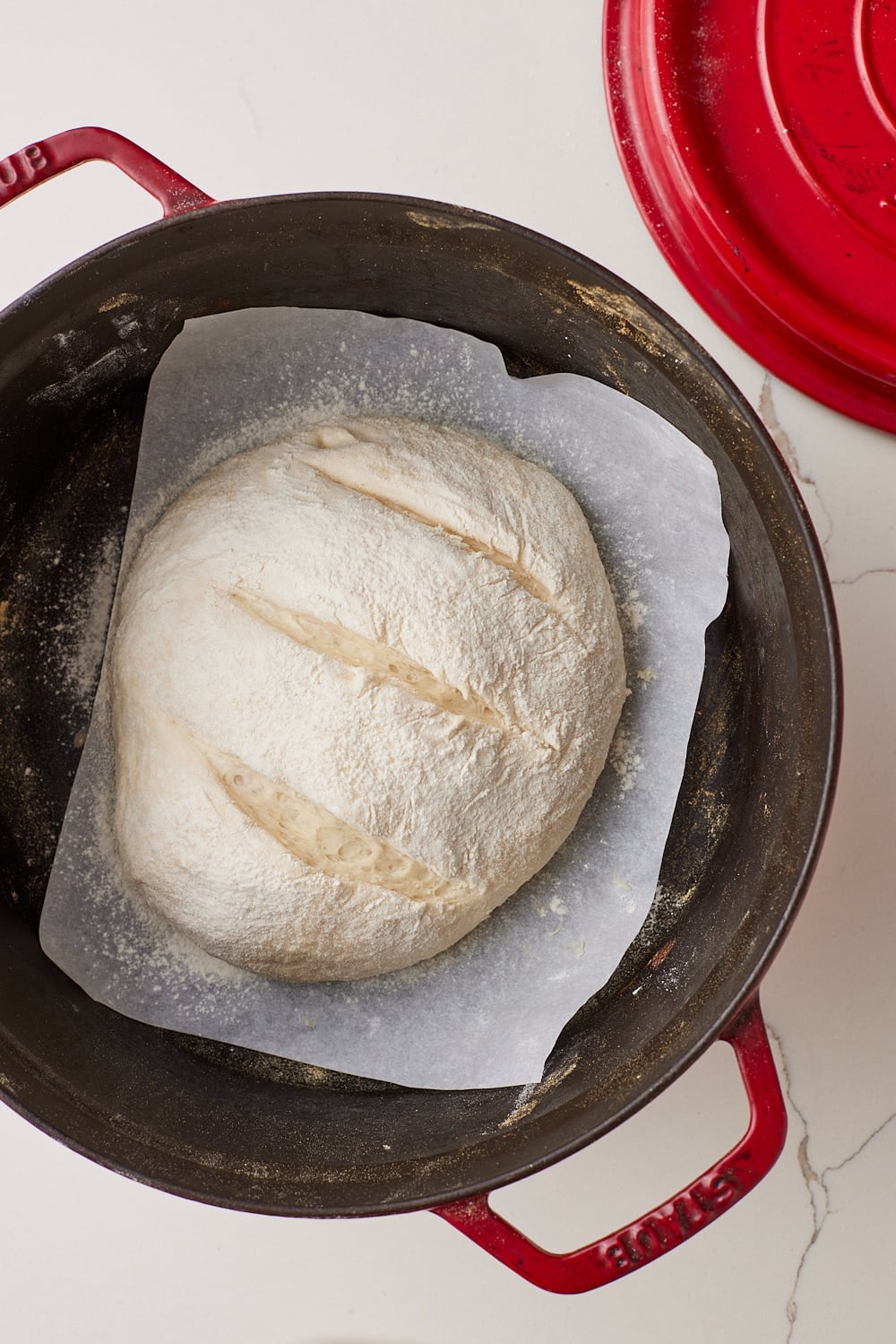 Score the loaf: Score the top of the loaf with a sharp knife, then place the lid back on.