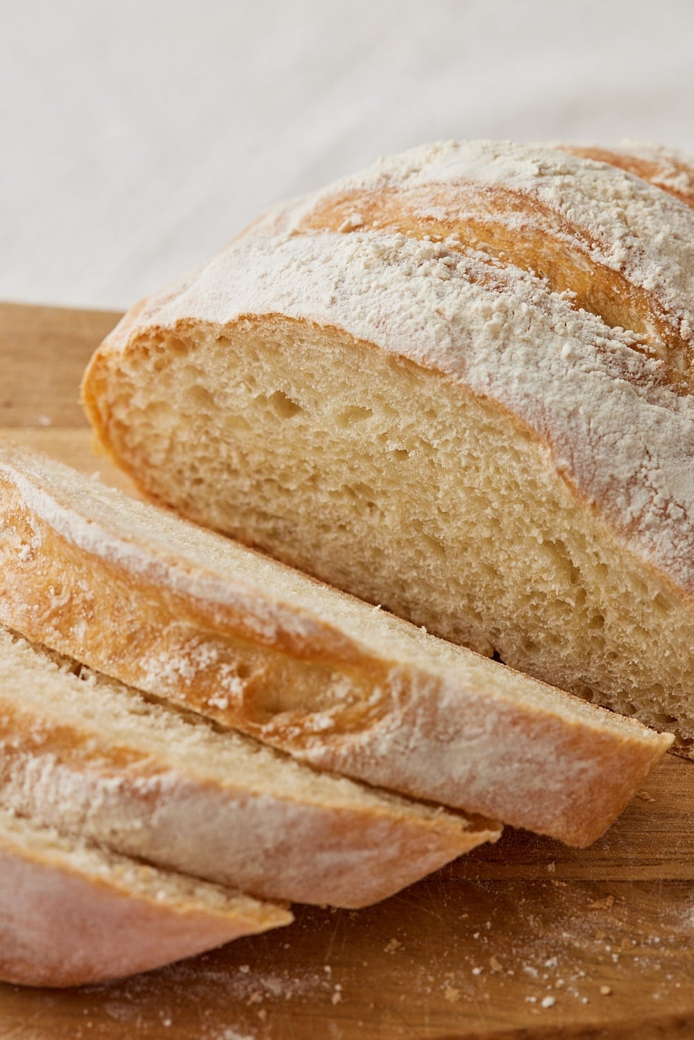 Sliced small bread shows crusty crumb. 