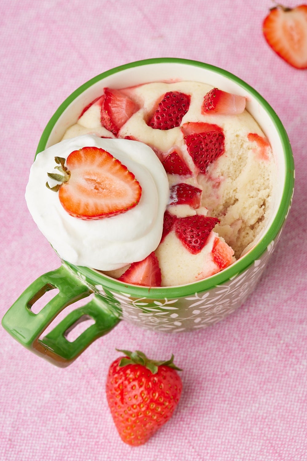 Strawberry Shortcake Mug Cake9 Strawberry Shortcake Mug Cake served with fresh strawberries and whipped cream.