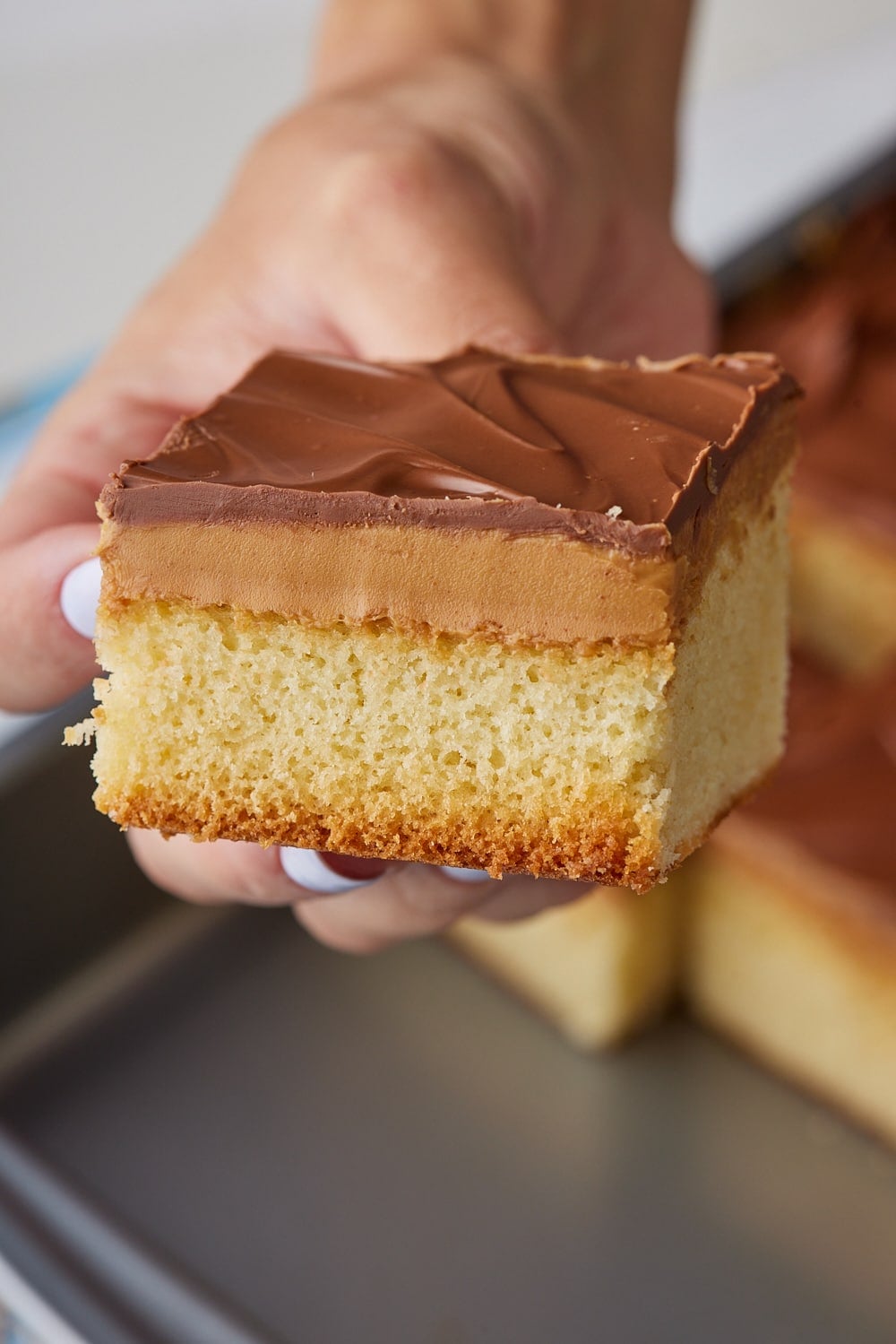 Tandy Cake13 A close-up shot at a square of Tandy Cake showing the layers of sponge cake, peanut butter, and chocolate.