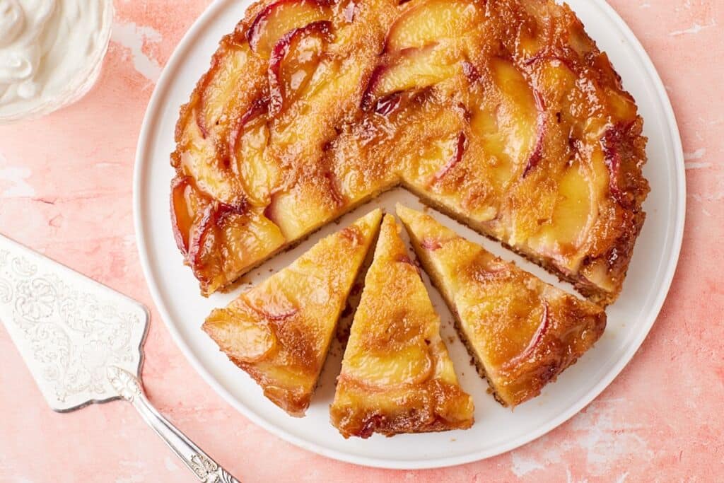 Top-down view of Peach Upside Down Cake, with three slices.